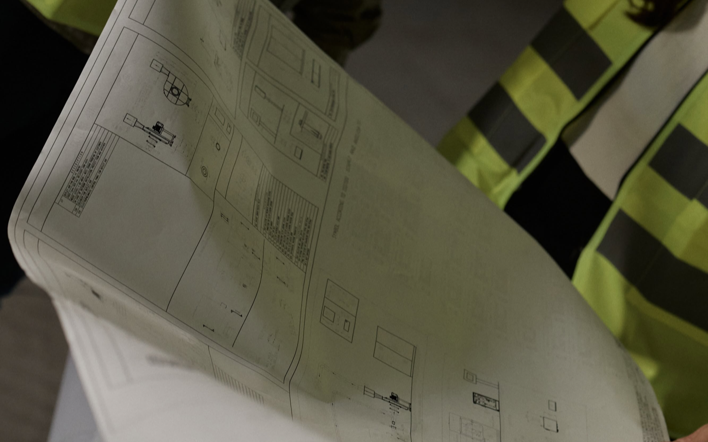 Engineers reviewing facility drawings on site
